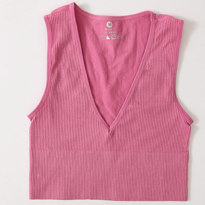 Women's pink ribbed seamless tank top with deep V-neck, perfect for sport, yoga, and running. Comfortable and form-fitting.